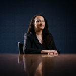 Tabbye Chavous sitting behind a table.