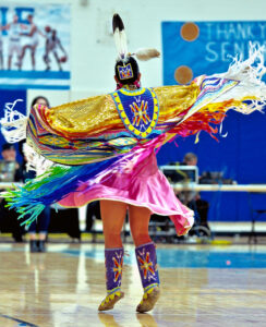 person dancing in colorful native clothing.